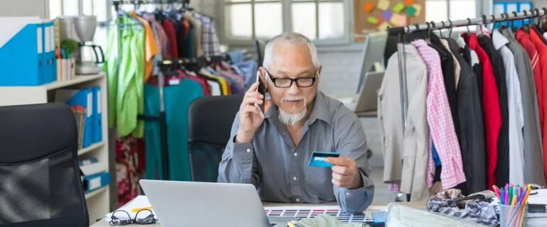 Male designer calling to question credit card processing fees