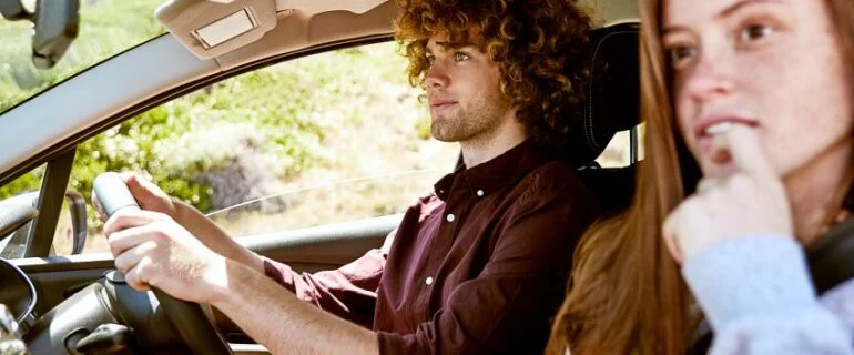 Young man driving with girlfriend