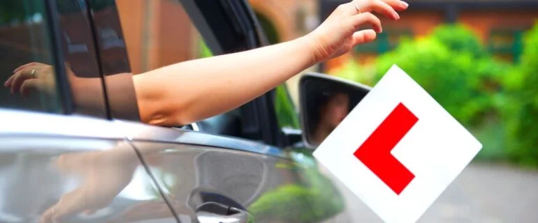 New just driver just passed test dropping L plates out of car window while driving